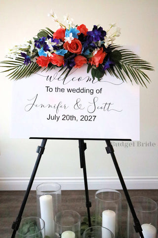 Wedding Sign Flowers that easily accent flowers to attach to a standing easle wedding sign to be used at ceremony or reception in tropical beach theme flowers orchids, roses, palm leaves