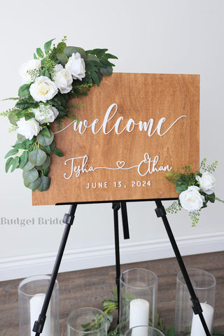 Wedding Sign Flowers that easily accent flowers to attach to a standing easle wedding sign to be used at ceremony or reception in white roses with eucalyptus greenery