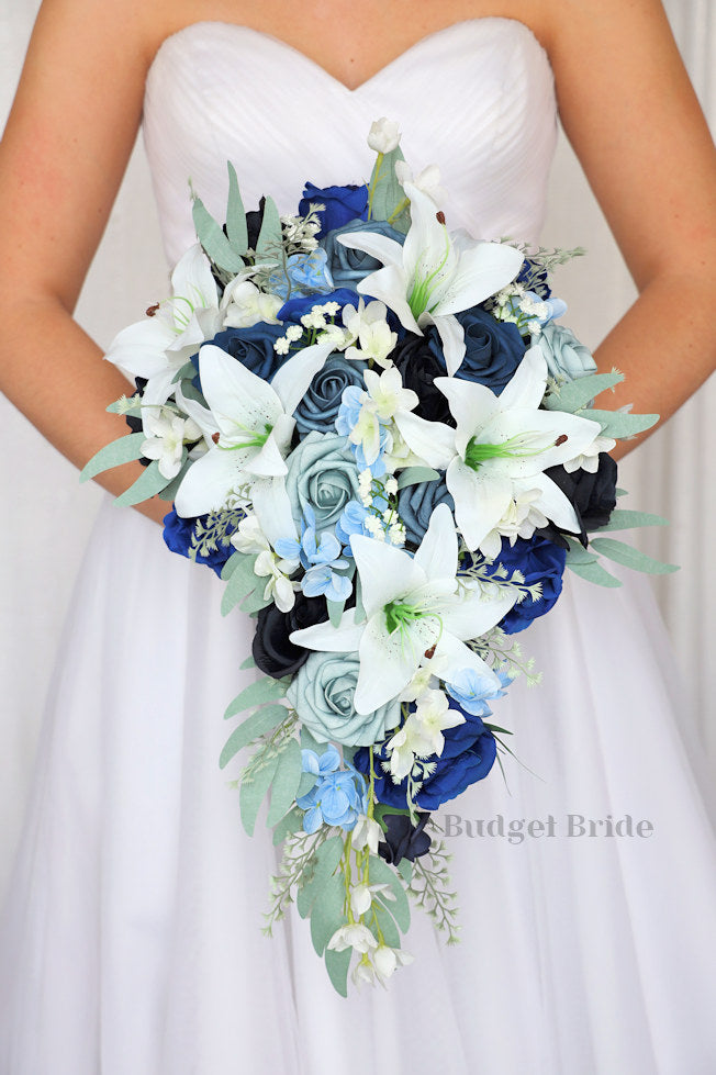 Brides Bouquet with white tiger lilies, dusty blue, ink blue, steel blue and navy blue roses with light blue hydrangea and sage greenery