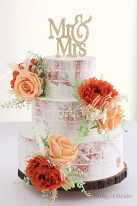 Boho naked wedding cake with burnt orange and rust flowers